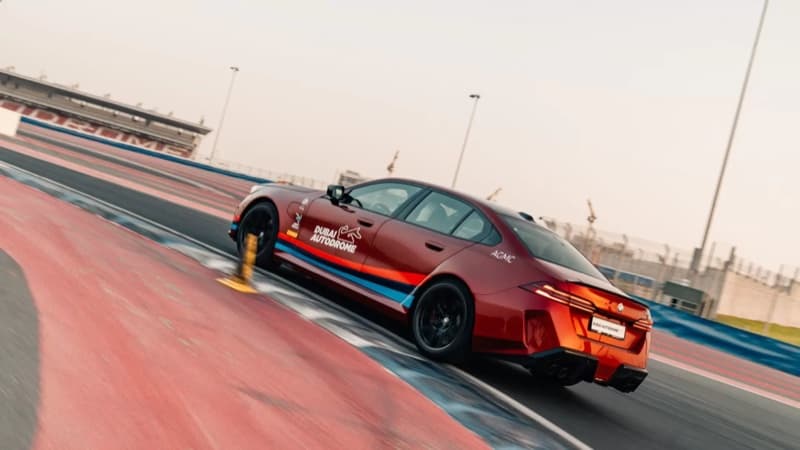 A sports car cornering on the Dubai Autodrome circuit